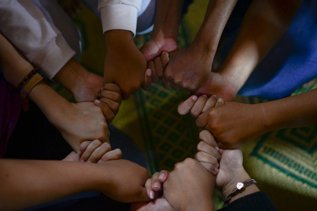 diverse group holding hands in circle