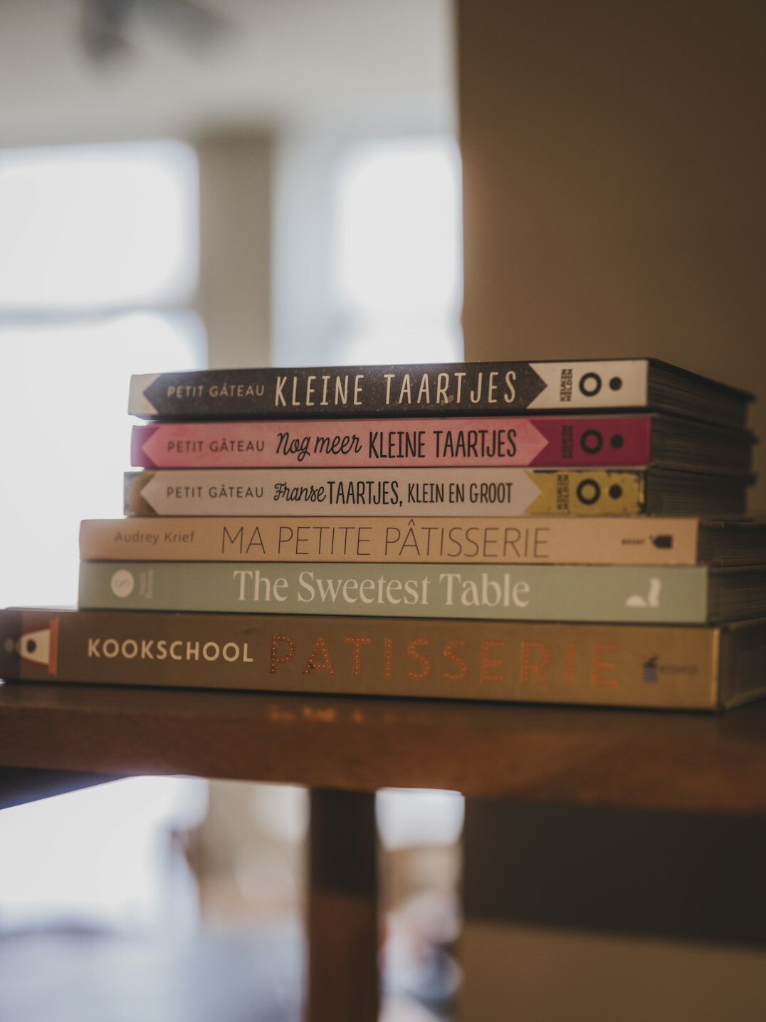 Stack of books in muted colors on a table
